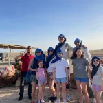 Agafay Desert Morocco: A Unique Desert Experience Near Marrakech The Agafay Desert in Morocco is a stunning and peaceful destination located just 40 minutes from Marrakech. For travelers from the United States looking for a memorable and accessible desert experience, Agafay offers the perfect combination of adventure, comfort, and authenticity. Unlike the Sahara sand dunes, the Agafay Desert is a rocky desert landscape with wide open plains, gentle hills, and breathtaking views of the Atlas Mountains. This makes it an excellent choice for visitors who want a desert tour near Marrakech without long driving days. Agafay has become especially popular among American families traveling to Morocco, honeymoon couples, and private tour guests seeking a luxury yet relaxed desert experience. ⸻ Why American Travelers Choose the Agafay Desert For visitors searching online for “desert tour from Marrakech” or “Agafay Desert tour Morocco”, Agafay stands out for several reasons: • Easy access from Marrakech hotels and riads • Ideal for private family tours in Morocco • Luxury desert camps with modern comfort • Camel rides, quad biking, and sunset experiences • Traditional Moroccan dinner under the stars The mild climate during winter makes Agafay an excellent choice for travelers booking a Christmas vacation in Morocco or a winter escape from the USA. ⸻ Christmas in Morocco: Agafay Desert Family Experience Spending Christmas in Morocco is a growing trend among American travelers. Instead of snow and cold weather, families enjoy sunshine, open landscapes, and warm Moroccan hospitality. With Moroccan Odyssey, guests can book a 12-day private Morocco tour that includes cities, culture, and a relaxing stop in the Agafay Desert. Each itinerary is custom-designed to fit family needs, travel pace, and interests. ⸻ Picture Explanation (Optimized for SEO & ALT Text) This photo shows our experienced local Moroccan guide with two families from the United States enjoying their Christmas holiday in Morocco during a 12-day private family tour organized by Moroccan Odyssey. The picture was taken in the Agafay Desert near Marrakech, where the families stopped to enjoy a desert experience together. Wearing traditional desert scarves, both adults and children embraced the local culture while discovering one of Morocco’s most beautiful natural landscapes. This moment perfectly represents what American travelers look for when searching for private Morocco tours, family-friendly desert experiences, and custom Morocco travel packages. Two American families enjoy a memorable Christmas vacation in Morocco during a 12-day private family tour with Moroccan Odyssey, captured in the stunning Agafay Desert near Marrakech. Guided by an experienced local guide, both adults and children discover Morocco’s unique desert landscape, culture, and hospitality in a safe, personalized, and family-friendly travel experience. A magical Christmas in Morocco ✨ Two American families discovering the Agafay Desert during their 12-day private family tour.