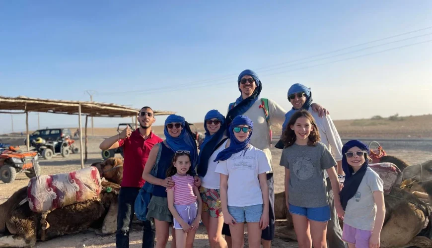 Agafay Desert Morocco: A Unique Desert Experience Near Marrakech The Agafay Desert in Morocco is a stunning and peaceful destination located just 40 minutes from Marrakech. For travelers from the United States looking for a memorable and accessible desert experience, Agafay offers the perfect combination of adventure, comfort, and authenticity. Unlike the Sahara sand dunes, the Agafay Desert is a rocky desert landscape with wide open plains, gentle hills, and breathtaking views of the Atlas Mountains. This makes it an excellent choice for visitors who want a desert tour near Marrakech without long driving days. Agafay has become especially popular among American families traveling to Morocco, honeymoon couples, and private tour guests seeking a luxury yet relaxed desert experience. ⸻ Why American Travelers Choose the Agafay Desert For visitors searching online for “desert tour from Marrakech” or “Agafay Desert tour Morocco”, Agafay stands out for several reasons: • Easy access from Marrakech hotels and riads • Ideal for private family tours in Morocco • Luxury desert camps with modern comfort • Camel rides, quad biking, and sunset experiences • Traditional Moroccan dinner under the stars The mild climate during winter makes Agafay an excellent choice for travelers booking a Christmas vacation in Morocco or a winter escape from the USA. ⸻ Christmas in Morocco: Agafay Desert Family Experience Spending Christmas in Morocco is a growing trend among American travelers. Instead of snow and cold weather, families enjoy sunshine, open landscapes, and warm Moroccan hospitality. With Moroccan Odyssey, guests can book a 12-day private Morocco tour that includes cities, culture, and a relaxing stop in the Agafay Desert. Each itinerary is custom-designed to fit family needs, travel pace, and interests. ⸻ Picture Explanation (Optimized for SEO & ALT Text) This photo shows our experienced local Moroccan guide with two families from the United States enjoying their Christmas holiday in Morocco during a 12-day private family tour organized by Moroccan Odyssey. The picture was taken in the Agafay Desert near Marrakech, where the families stopped to enjoy a desert experience together. Wearing traditional desert scarves, both adults and children embraced the local culture while discovering one of Morocco’s most beautiful natural landscapes. This moment perfectly represents what American travelers look for when searching for private Morocco tours, family-friendly desert experiences, and custom Morocco travel packages. Two American families enjoy a memorable Christmas vacation in Morocco during a 12-day private family tour with Moroccan Odyssey, captured in the stunning Agafay Desert near Marrakech. Guided by an experienced local guide, both adults and children discover Morocco’s unique desert landscape, culture, and hospitality in a safe, personalized, and family-friendly travel experience. A magical Christmas in Morocco ✨ Two American families discovering the Agafay Desert during their 12-day private family tour.