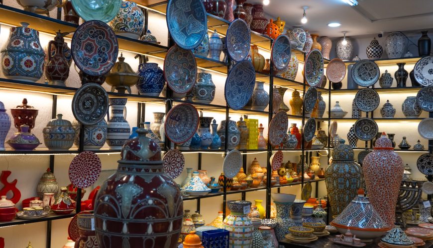 Traditional Fes pottery workshop inside the Medina of Fes, Morocco with handmade blue ceramic plates and tagines