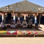 Traditional Gnawa musicians performing in a Berber nomad village in the Sahara Desert of Morocco near Merzouga.